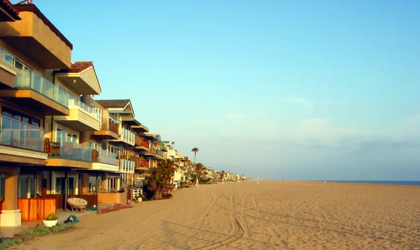 Beachfront homes of Surfside Colony along the sand, looking south down the beach