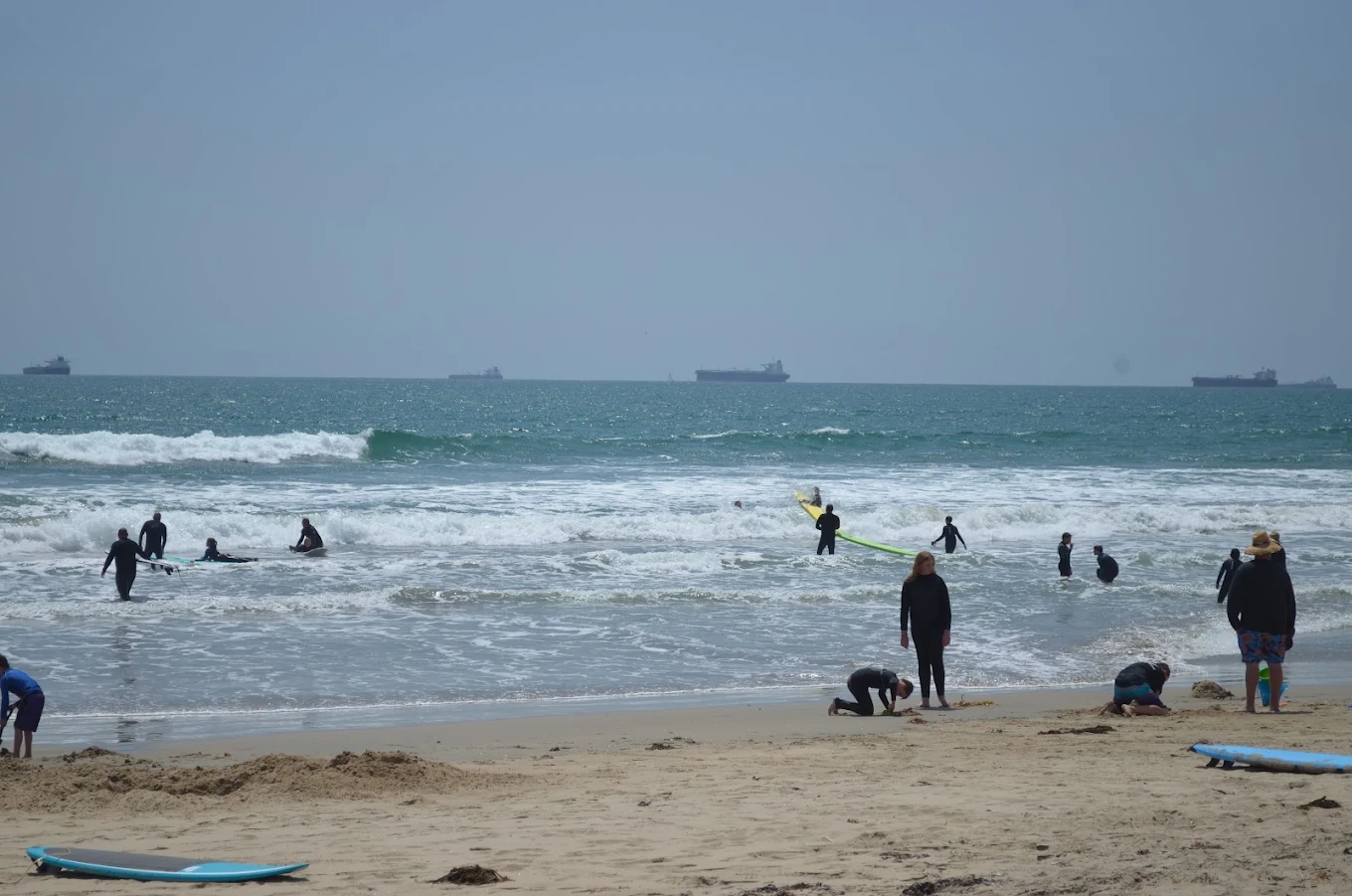 Surf students and instructors in the water at Huntington Beach